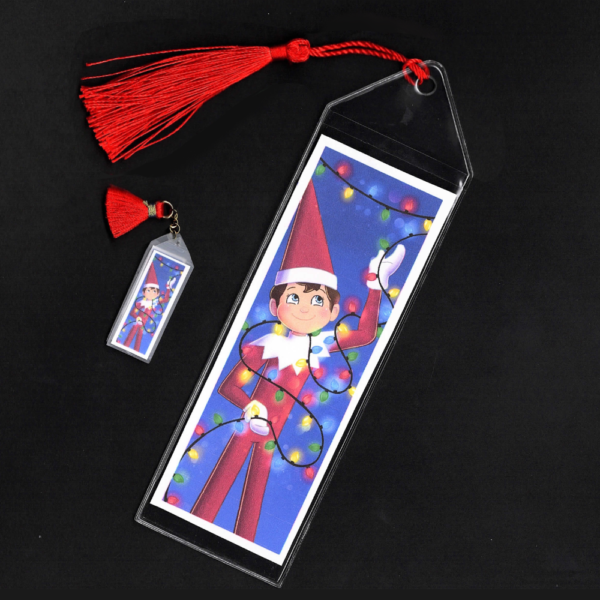 Blue-eyed boy Elf on the Shelf bookmark and mini bookmark with red tassels by L.C. Ireland, accordingtolc