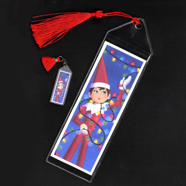 Blue-eyed girl Elf on the Shelf bookmark and mini bookmark with red tassels by L.C. Ireland, accordingtolc