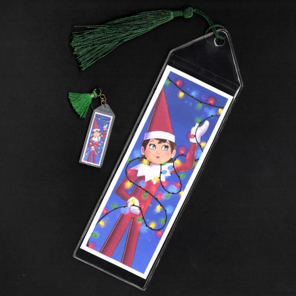 Blue-eyed girl Elf on the Shelf bookmark and mini bookmark with green tassels by L.C. Ireland, accordingtolc