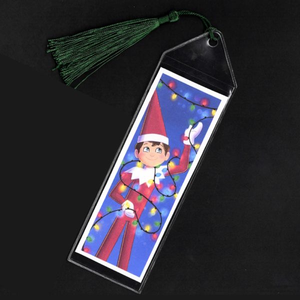 Blue-eyed boy Elf on the Shelf bookmark with green tassel by L.C. Ireland, accordingtolc