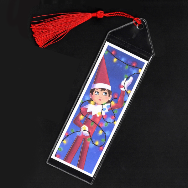 Blue-eyed girl Elf on the Shelf bookmark with red tassel by L.C. Ireland, accordingtolc