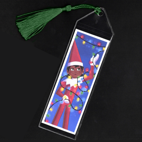 Brown-eyed girl Elf on the Shelf bookmark with green tassel by L.C. Ireland, accordingtolc